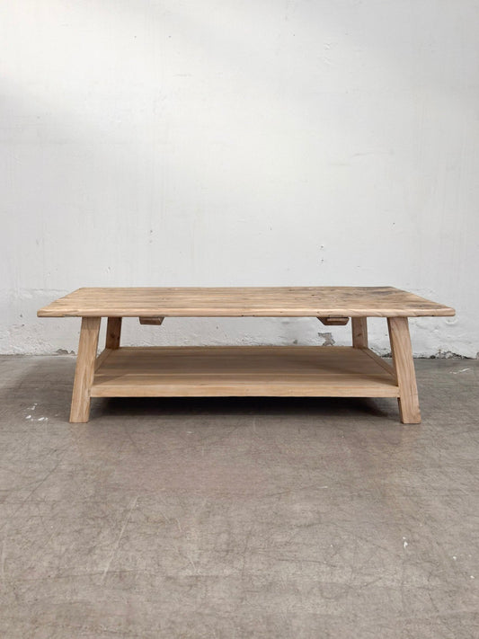 Wooden coffee table against a plain white wall